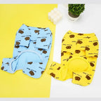 Blue and yellow brown bear printed french bulldog four leg pajamas flat lay product display on dual color background
