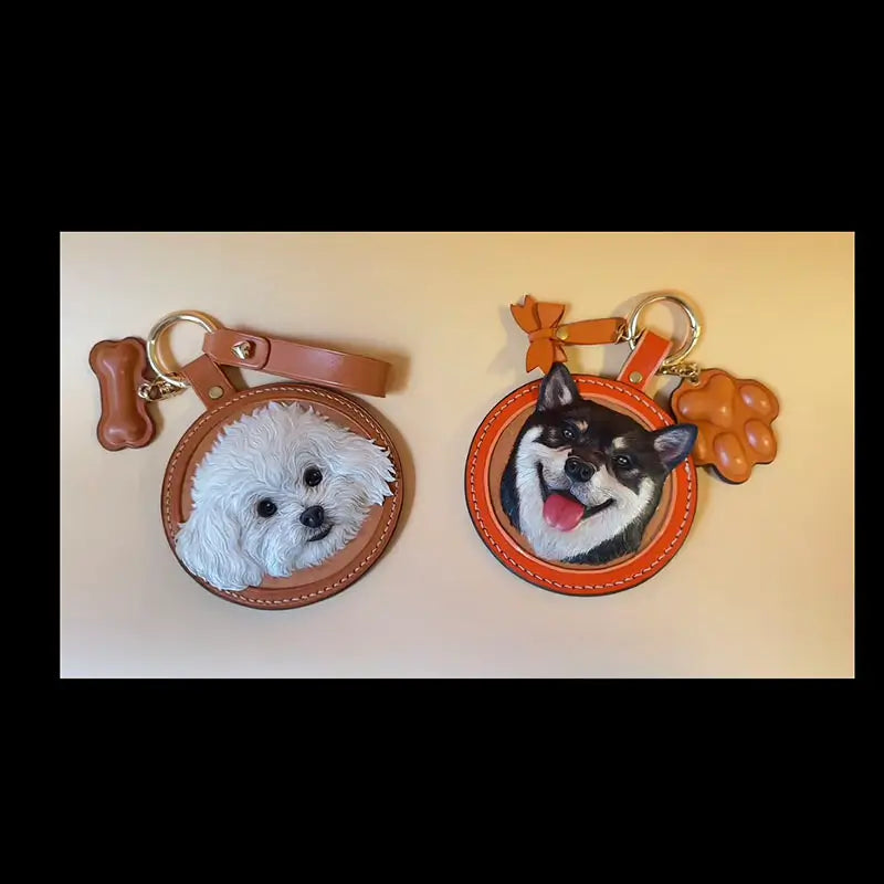 Two handmade custom leather dog portrait keychains, white bichon frise and black shiba inu personalized pet accessories
