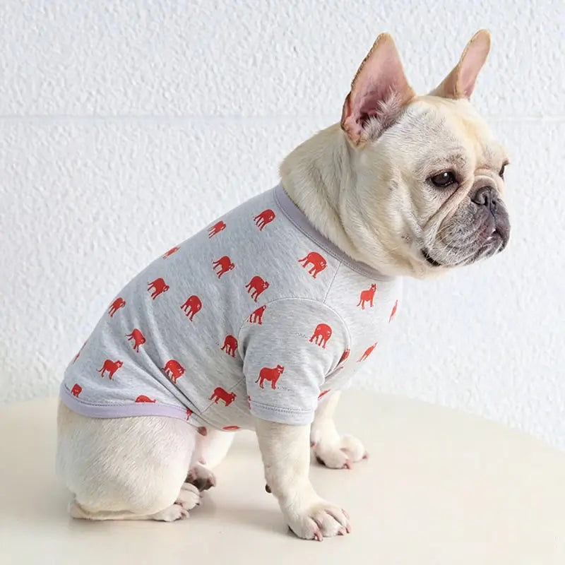 French Bulldog wearing matching red bulldog print cotton t-shirt, studio product photo