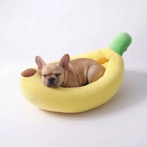 French Bulldog sound asleep on soft plush banana pet bed, warm enclosed nest bed reduces puppy anxiety