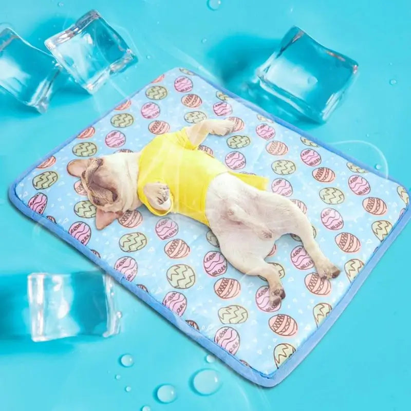 French Bulldog lying comfortably on a blue egg-patterned cooling pad, surrounded by ice cubes to show the pad’s cooling effect.