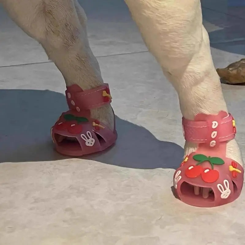 French Bulldog wearing pink pet sandals with cherry and rabbit designs, showing comfortable fit for indoor and outdoor use.