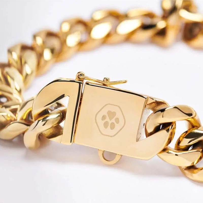 Gold Cuban link dog collar with engraved paw print heart on safety clasp, premium stainless steel luxury pet jewelry for French Bulldogs and bully breeds