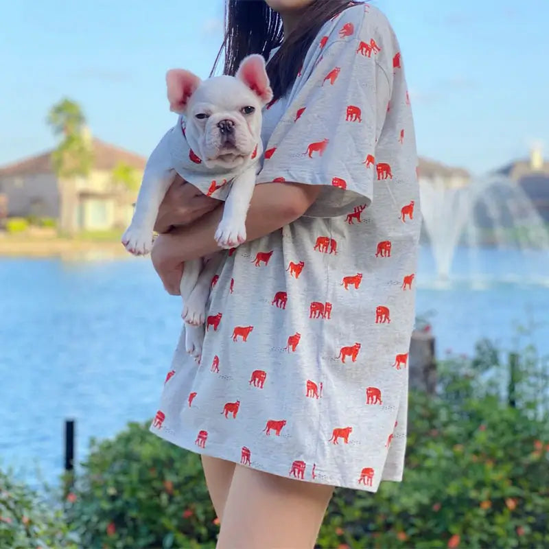 Matching French Bulldog and owner t-shirt set with red bulldog print, outdoor lifestyle photo