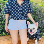 Navy blue star print matching shirt set for owner and French Bulldog, with the owner in a button-up shirt and shorts, and the Frenchie in a matching dog shirt.
