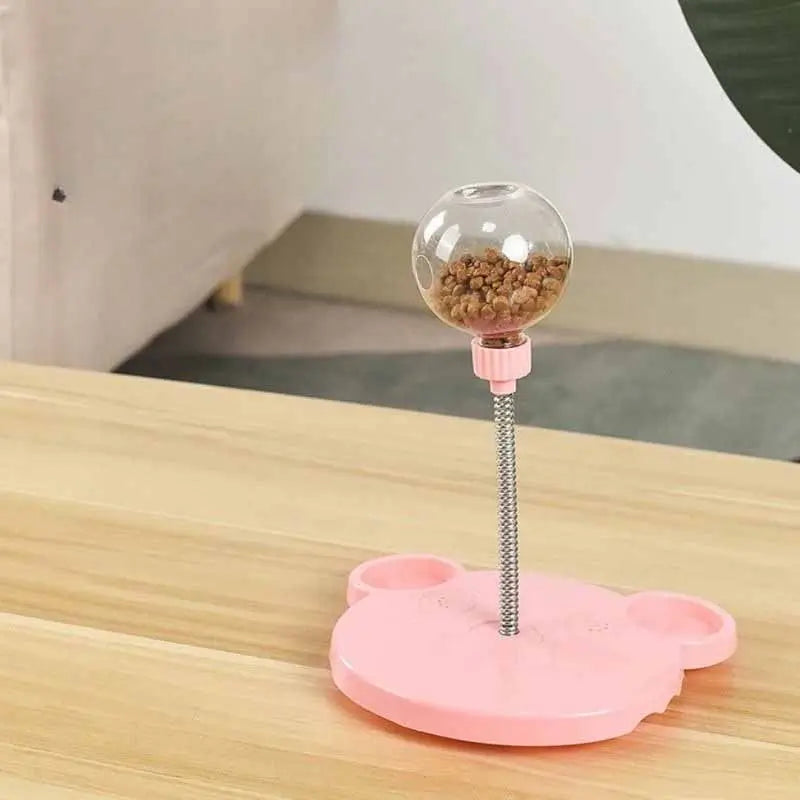 Pink interactive treat dispenser toy for French Bulldogs, slow feeder puzzle toy with spring stick design, ideal for small breeds