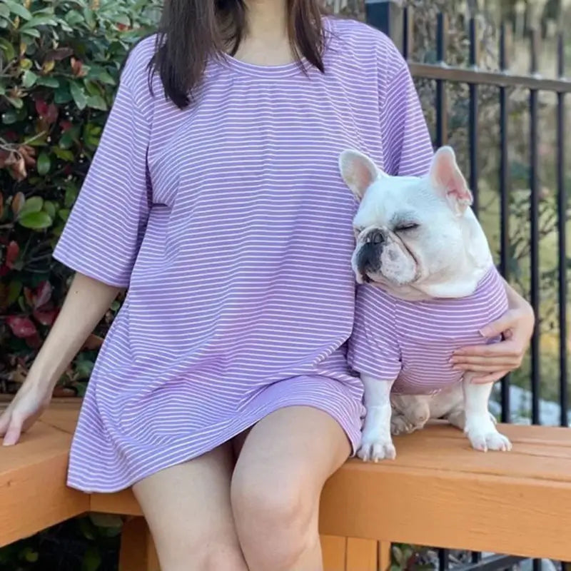 Matching purple and white striped outfit for owner and French Bulldog, featuring a relaxed women's dress and a fitted dog shirt.