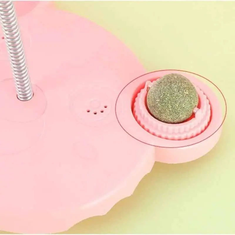 Close-up of pink French Bulldog treat dispenser toy base with rotating catnip ball, multi-functional interactive feeder toy
