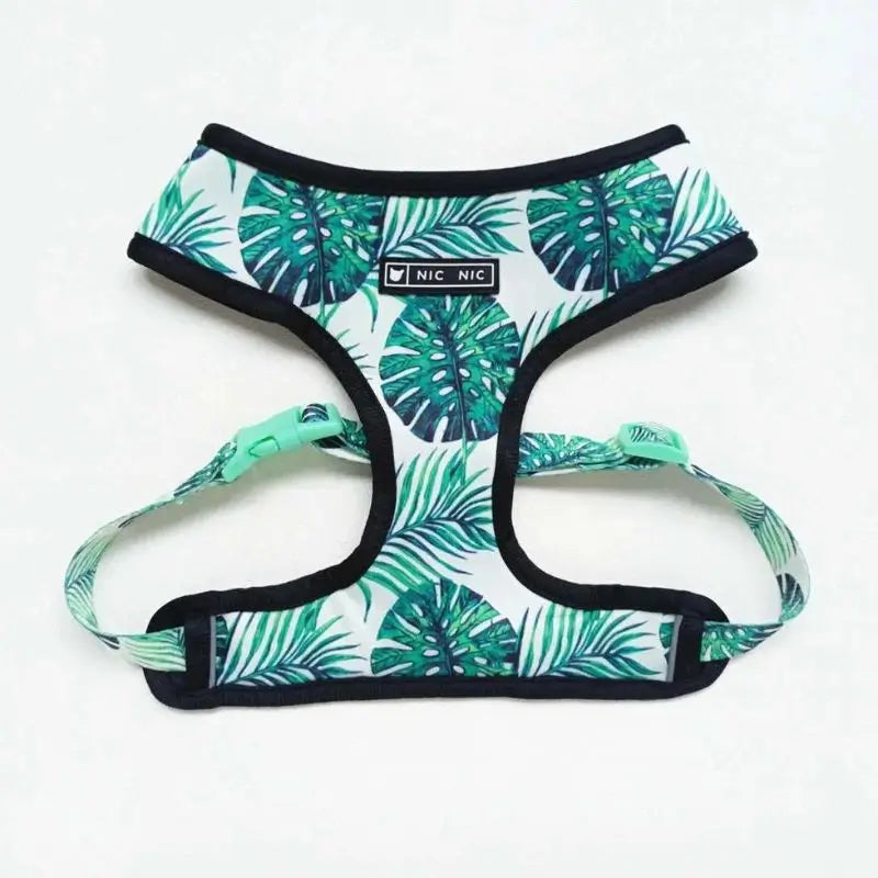 Tropical monstera leaf print dog harness for French Bulldogs, adjustable step-in vest with black trim and green accents.